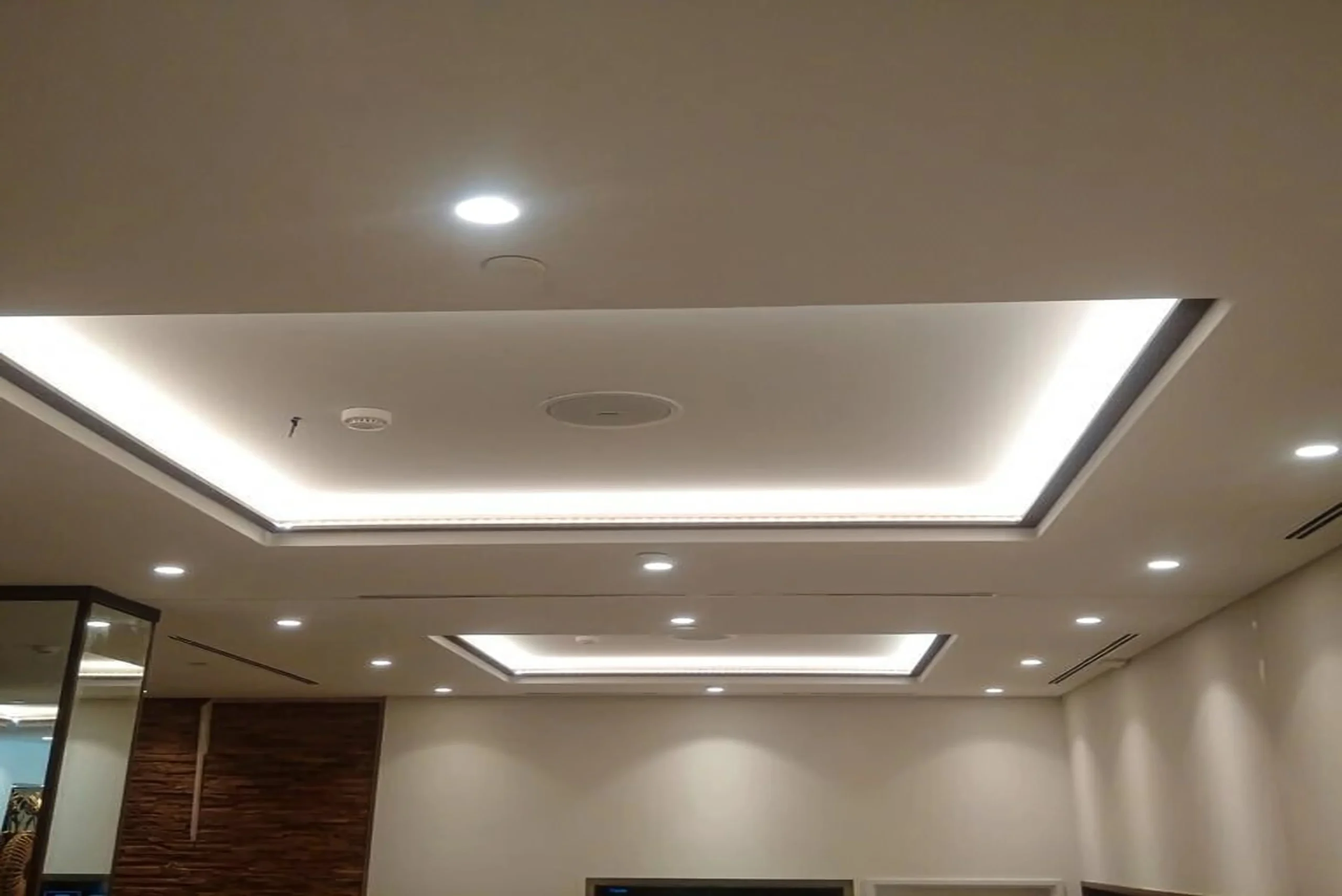 Modern living and dining area with a false ceiling and cove lighting